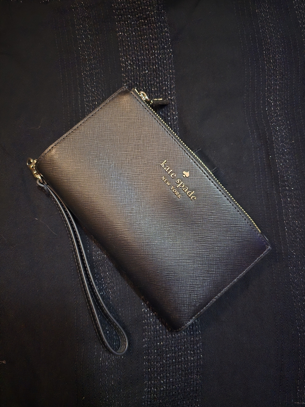 kate spade black leather wristlet with gold logo